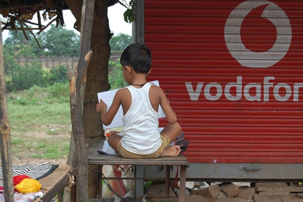 Child student reading outdoors