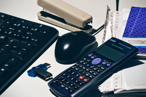 learning financial management skills calculator on desk in office