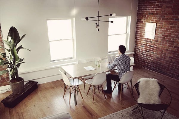 Man learning from home reading book