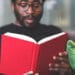 Man reading book - business school student learning from home