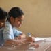 Student girl-teen in exam class room