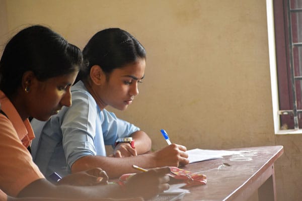 Student girl-teen in exam class room